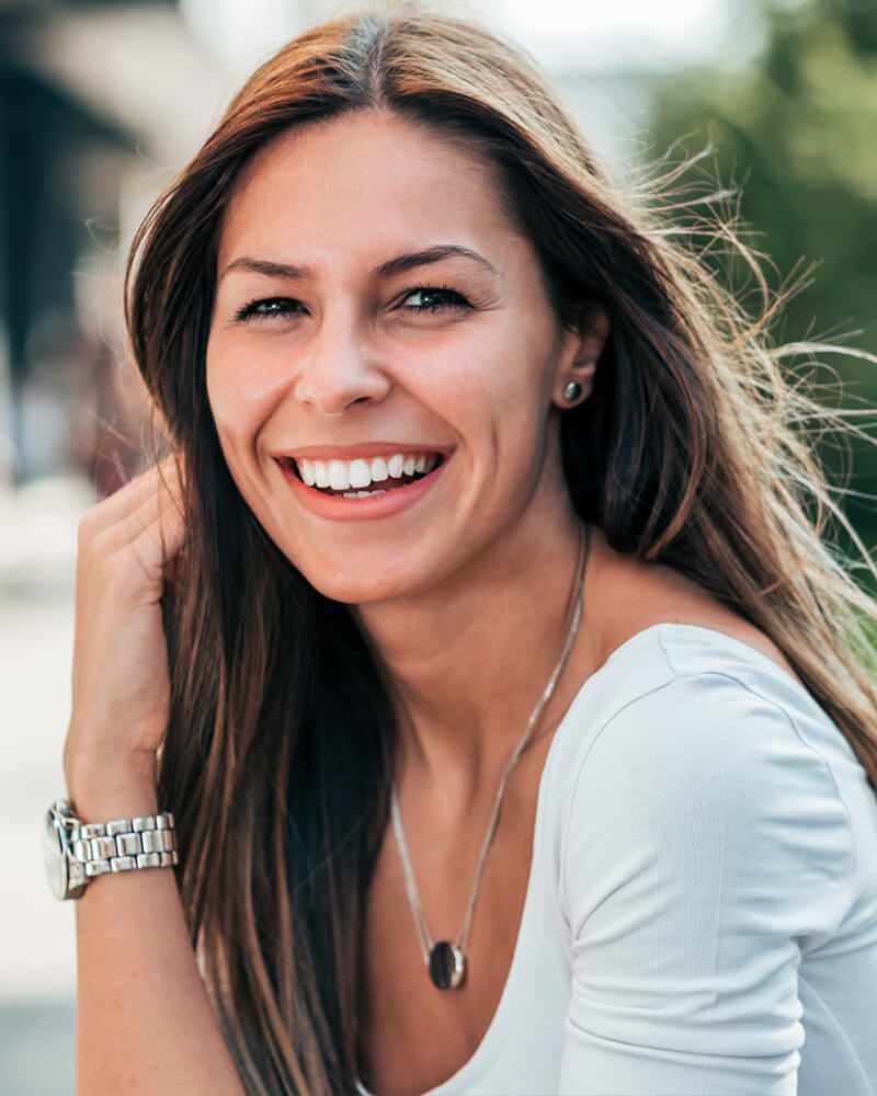 young woman sitting at a park