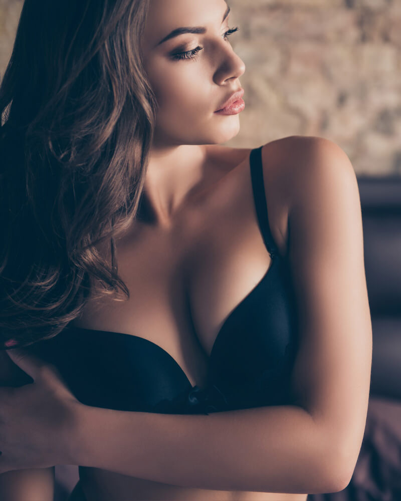 Young woman in a black bra