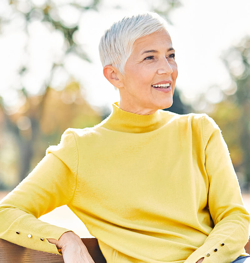 Mature woman in a yellow sweater