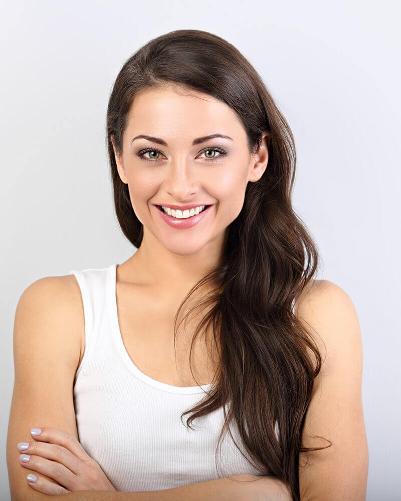 Woman with dark hair in a white undershirt