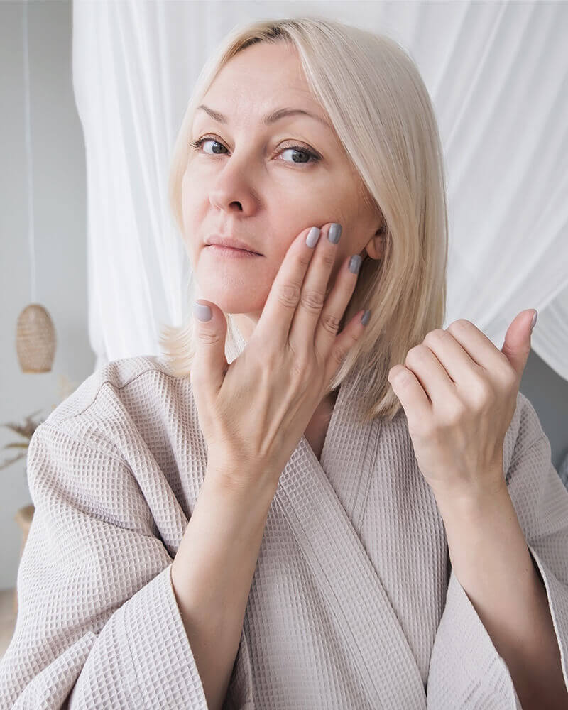 Mature woman rubbing her face