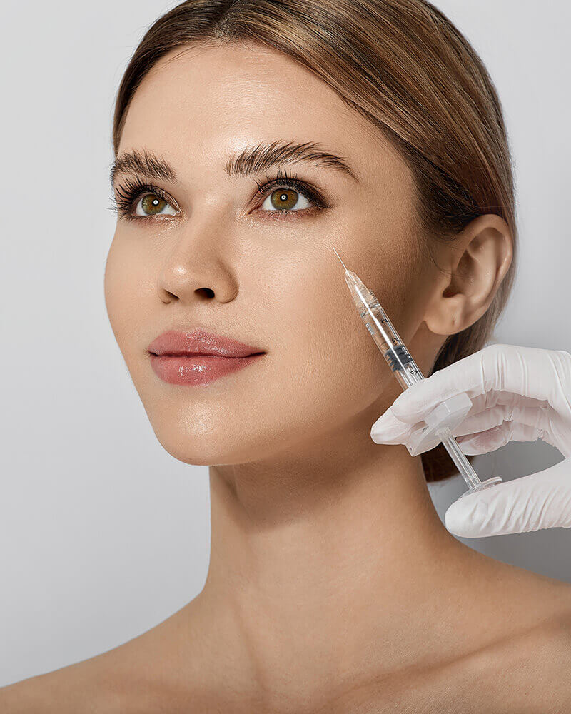 Young woman getting a facial injection