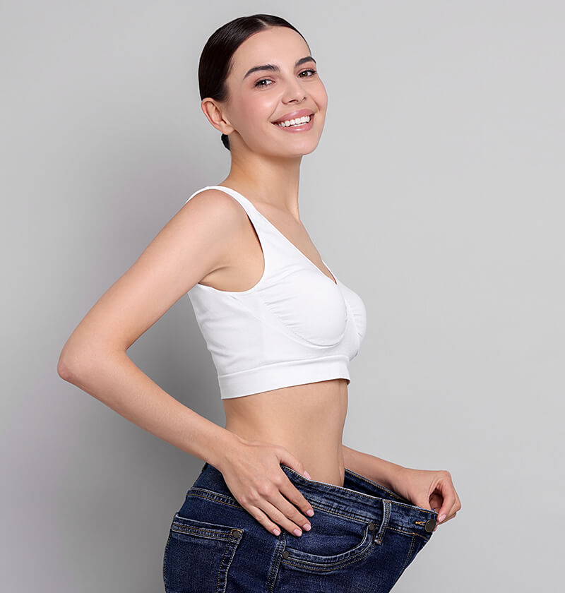 Fit woman with large jeans on