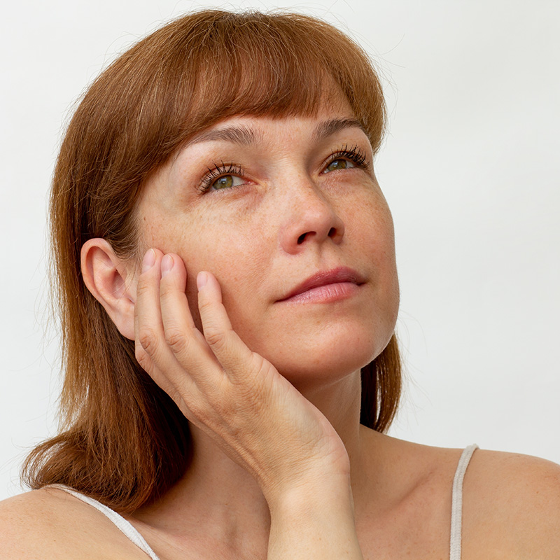 Woman touching her face